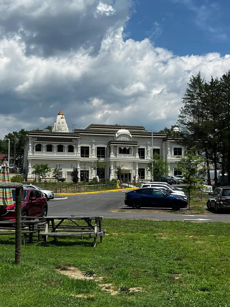 The full mandir with its shikhara and dome, seen across the lawn