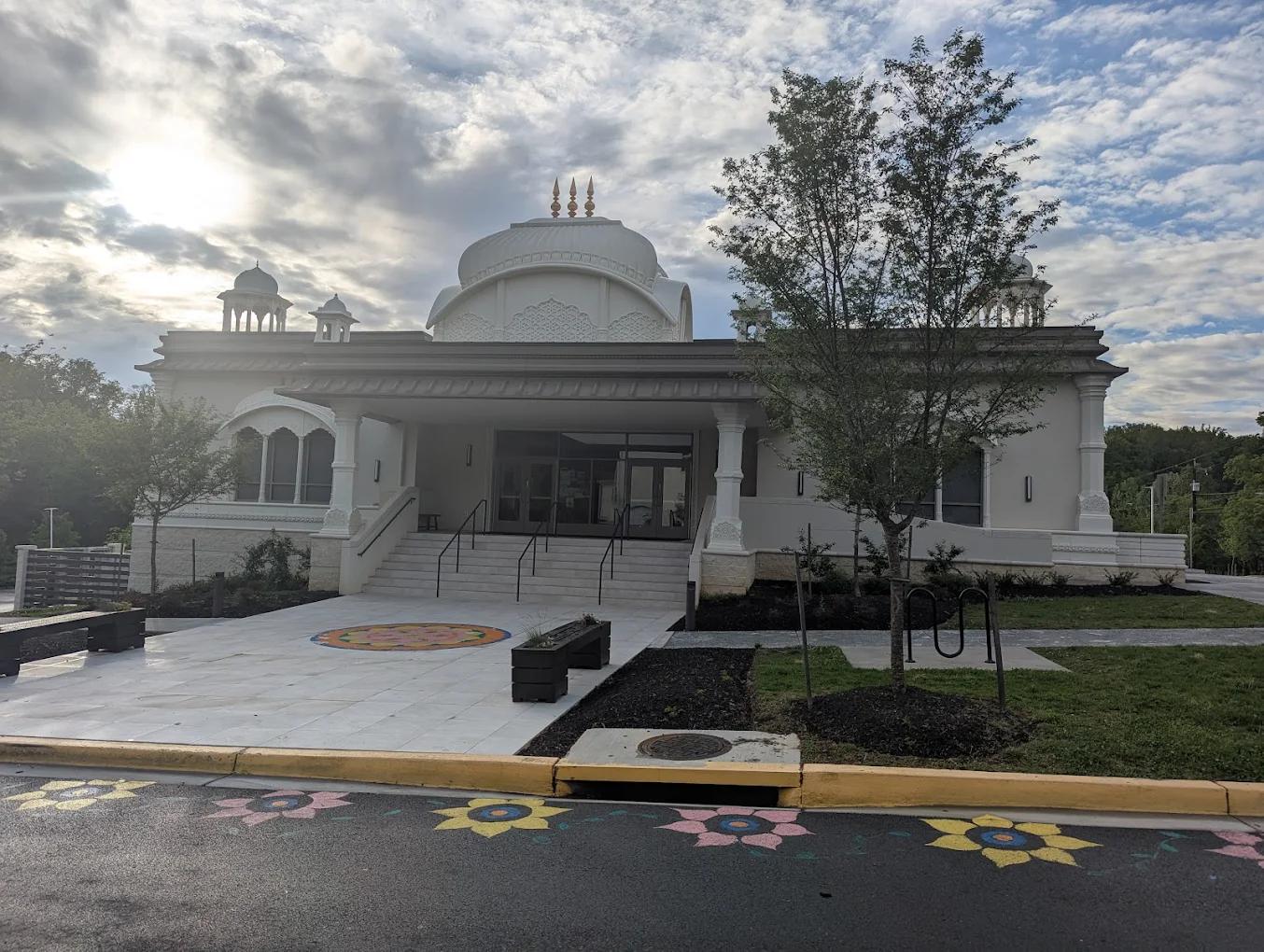The ISKCON temple near Washington, D.C. with a rangoli and painted flowers along the drive